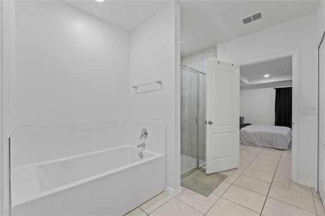 bathroom featuring tile patterned flooring and independent shower and bath