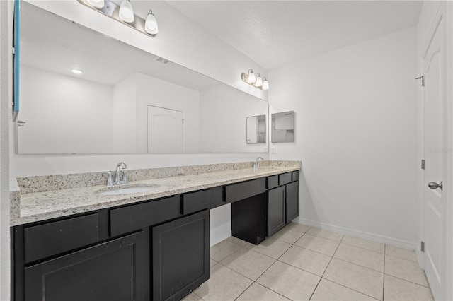 bathroom featuring tile patterned flooring and vanity