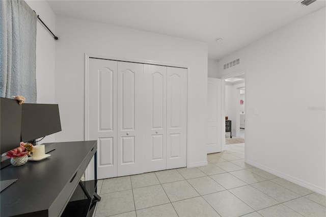 tiled bedroom with a closet