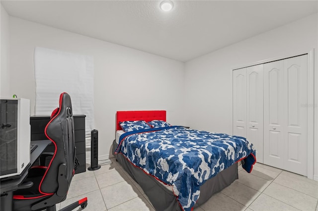 tiled bedroom with a closet