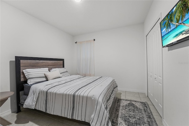 tiled bedroom featuring a closet