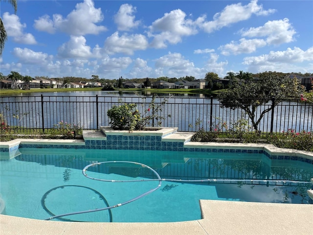 view of pool featuring a fenced in pool, a water view, and fence