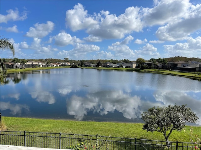 water view featuring a residential view and fence