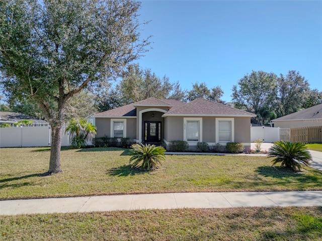 single story home featuring a front lawn