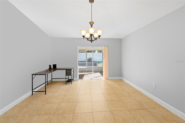 tiled empty room with a chandelier