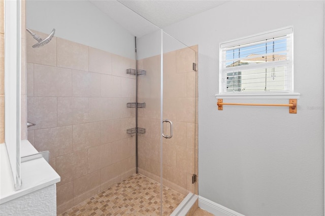 bathroom featuring a shower with door