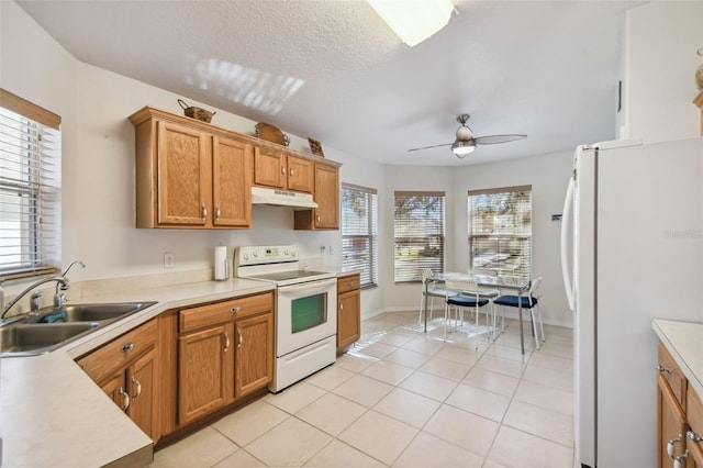 kitchen featuring ceiling fan, sink, a textured ceiling, white appliances, and light tile patterned floors