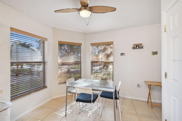 dining area featuring light tile patterned floors, ceiling fan, and a healthy amount of sunlight