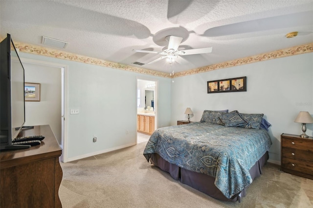 carpeted bedroom with ceiling fan, a textured ceiling, and connected bathroom