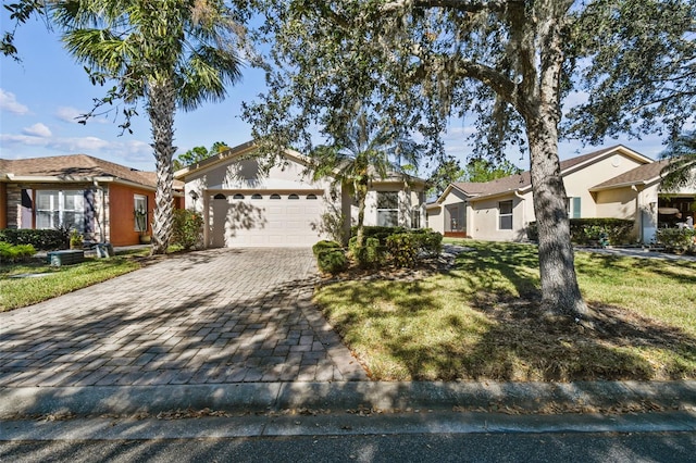 ranch-style home featuring a front lawn and a garage