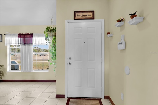 doorway to outside featuring light tile patterned floors