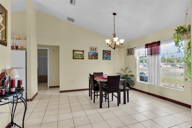 tiled dining space featuring a chandelier