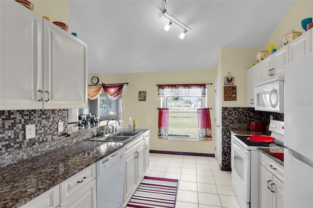 kitchen with light tile patterned floors, white appliances, white cabinetry, and sink