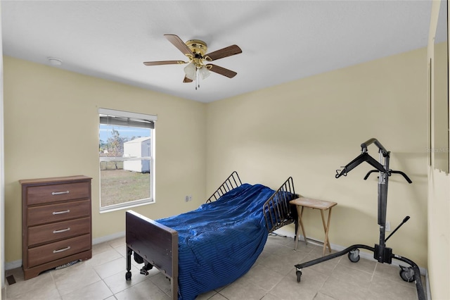 tiled bedroom featuring ceiling fan