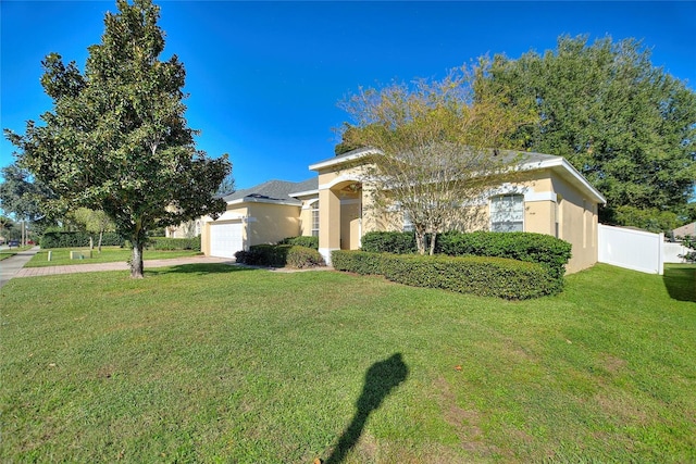 view of front of home with a front yard and a garage