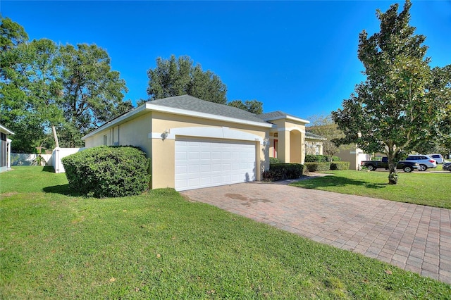 ranch-style house with a garage and a front lawn