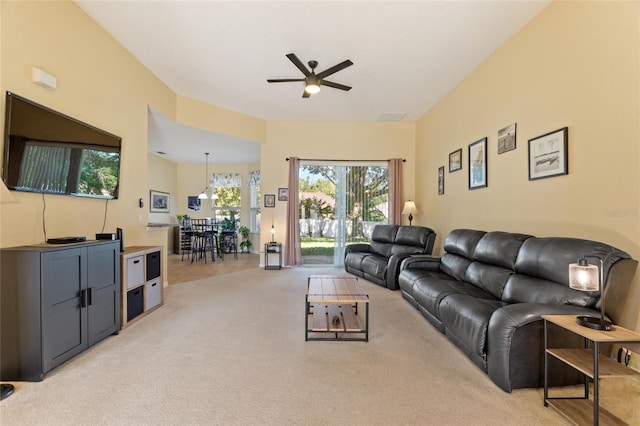 living room featuring light carpet and ceiling fan