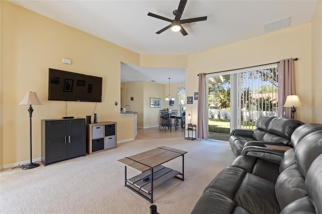 living room with light colored carpet and ceiling fan