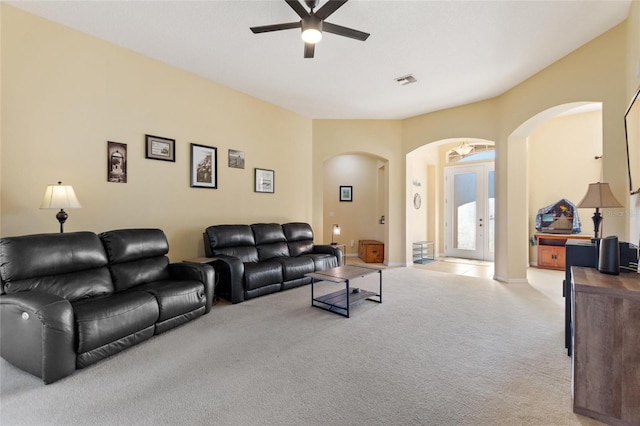 carpeted living room with ceiling fan