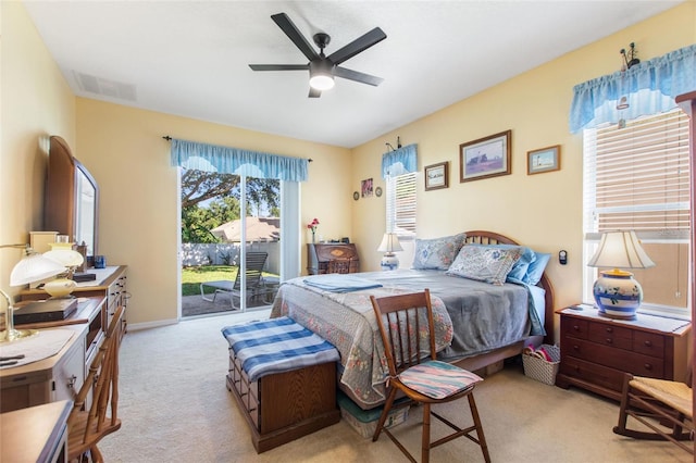 carpeted bedroom featuring access to outside and ceiling fan