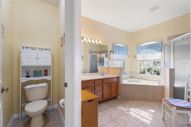 full bathroom featuring toilet, vanity, tile patterned flooring, and separate shower and tub