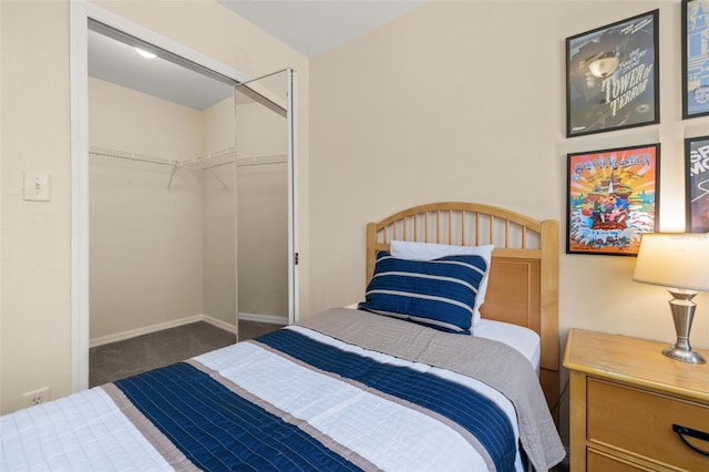 carpeted bedroom featuring a closet and baseboards