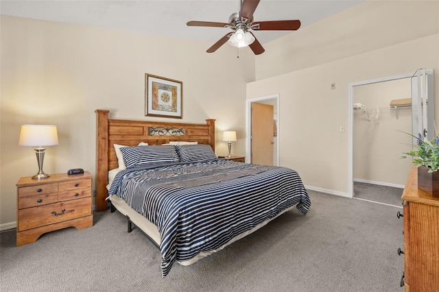 carpeted bedroom featuring baseboards, a ceiling fan, vaulted ceiling, and a closet