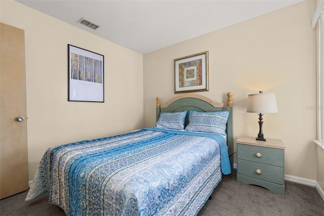 carpeted bedroom featuring visible vents and baseboards