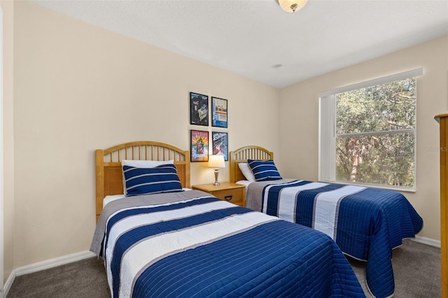 bedroom with carpet flooring and baseboards