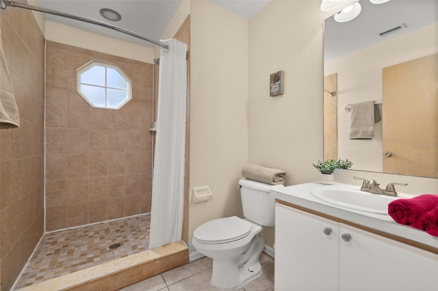 bathroom with toilet, a stall shower, tile patterned floors, and vanity