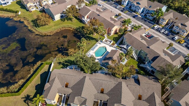 birds eye view of property featuring a water view and a residential view