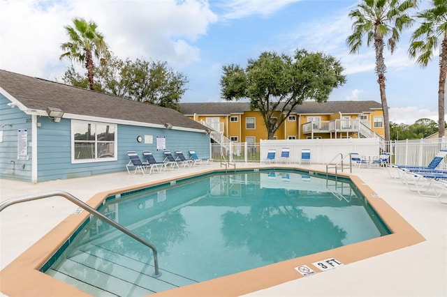 pool featuring a patio area and fence