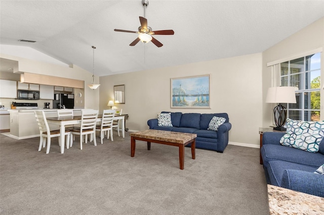 living room featuring light colored carpet, vaulted ceiling, and ceiling fan