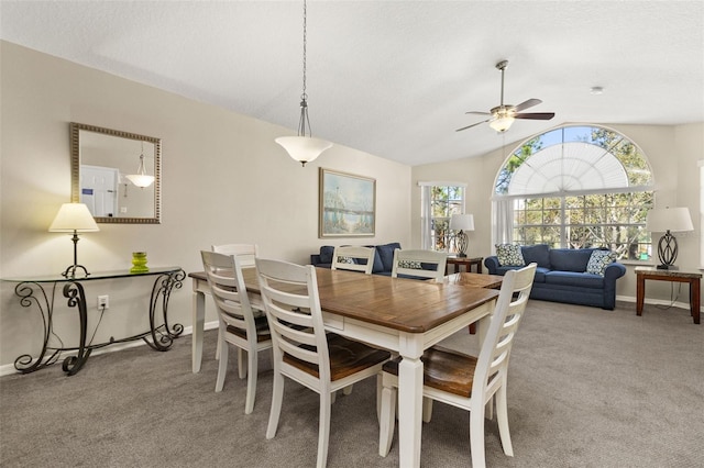 dining room with a textured ceiling, light colored carpet, ceiling fan, and lofted ceiling