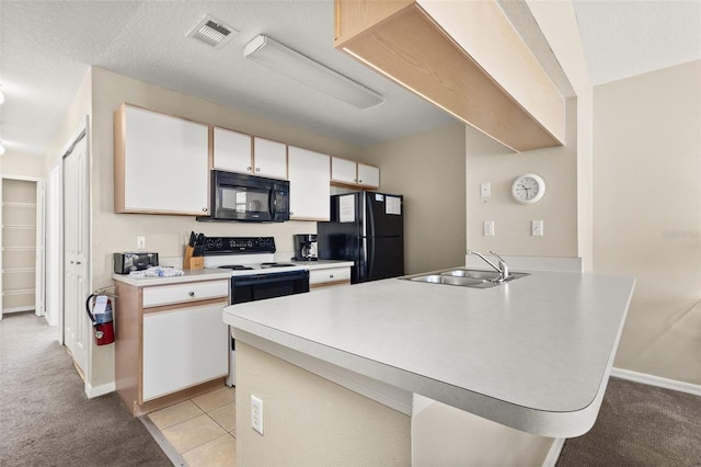 kitchen with black appliances, white cabinets, sink, and light carpet