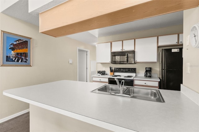 kitchen featuring kitchen peninsula, carpet flooring, white cabinetry, and black appliances