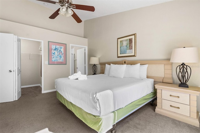 carpeted bedroom featuring a walk in closet, ceiling fan, and a closet