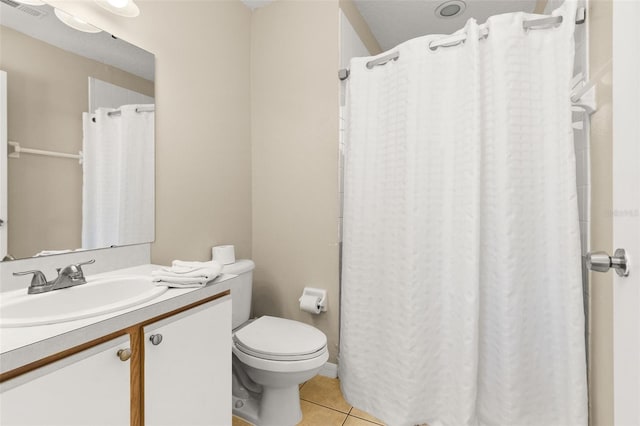 bathroom featuring tile patterned floors, vanity, and toilet