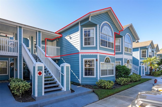 view of front of house featuring covered porch and stairway