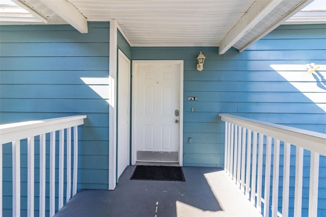 view of exterior entry with covered porch