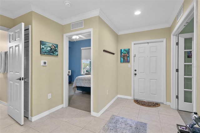 entryway featuring ornamental molding and light tile patterned flooring