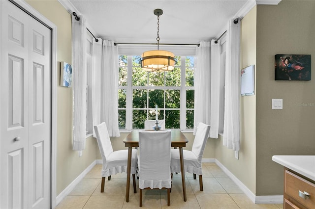 tiled dining space with an inviting chandelier