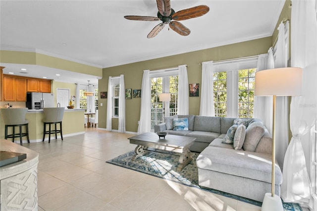 living room featuring ceiling fan, ornamental molding, and light tile patterned floors