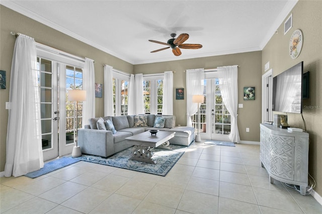 living room with ceiling fan, ornamental molding, light tile patterned floors, and french doors