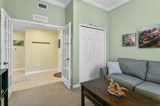 tiled living room with ornamental molding and french doors