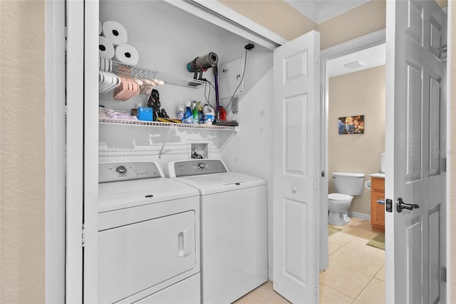 washroom featuring light tile patterned floors and washing machine and dryer