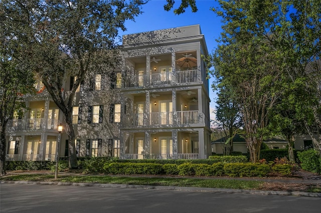 greek revival house featuring ceiling fan and a balcony