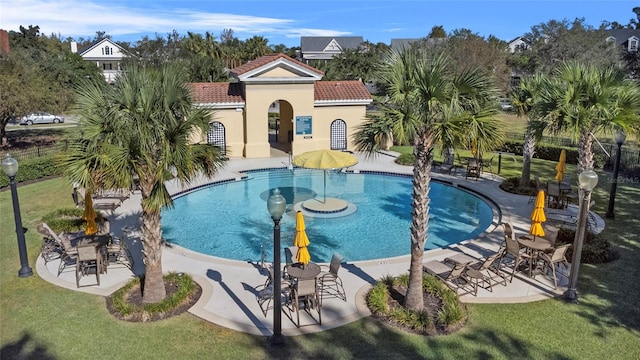 view of swimming pool with a lawn and a patio