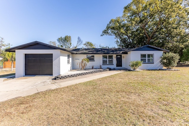 single story home with a front lawn and a garage