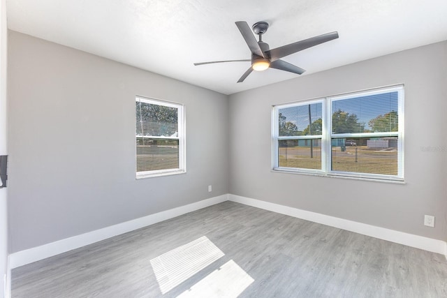 spare room with ceiling fan and light hardwood / wood-style floors